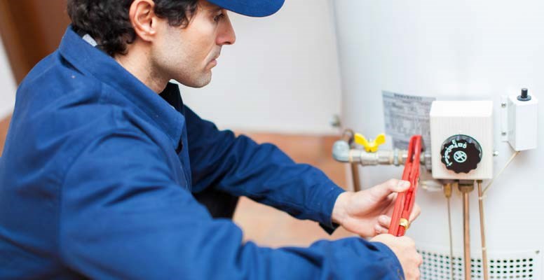 Repair man working on water heater