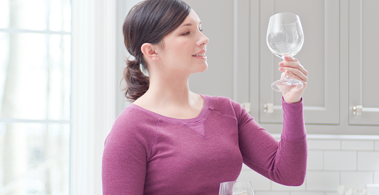 woman looking at wine glass