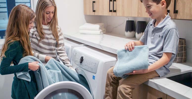 Mom and kids folding laundry